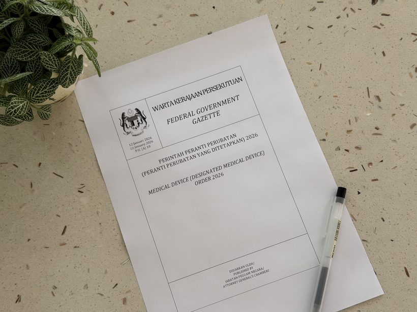 The printed cover of Malaysia's Federal Government Gazette for the Medical Device (Designated Medical Device) Order 2026, on a desk in daylight.